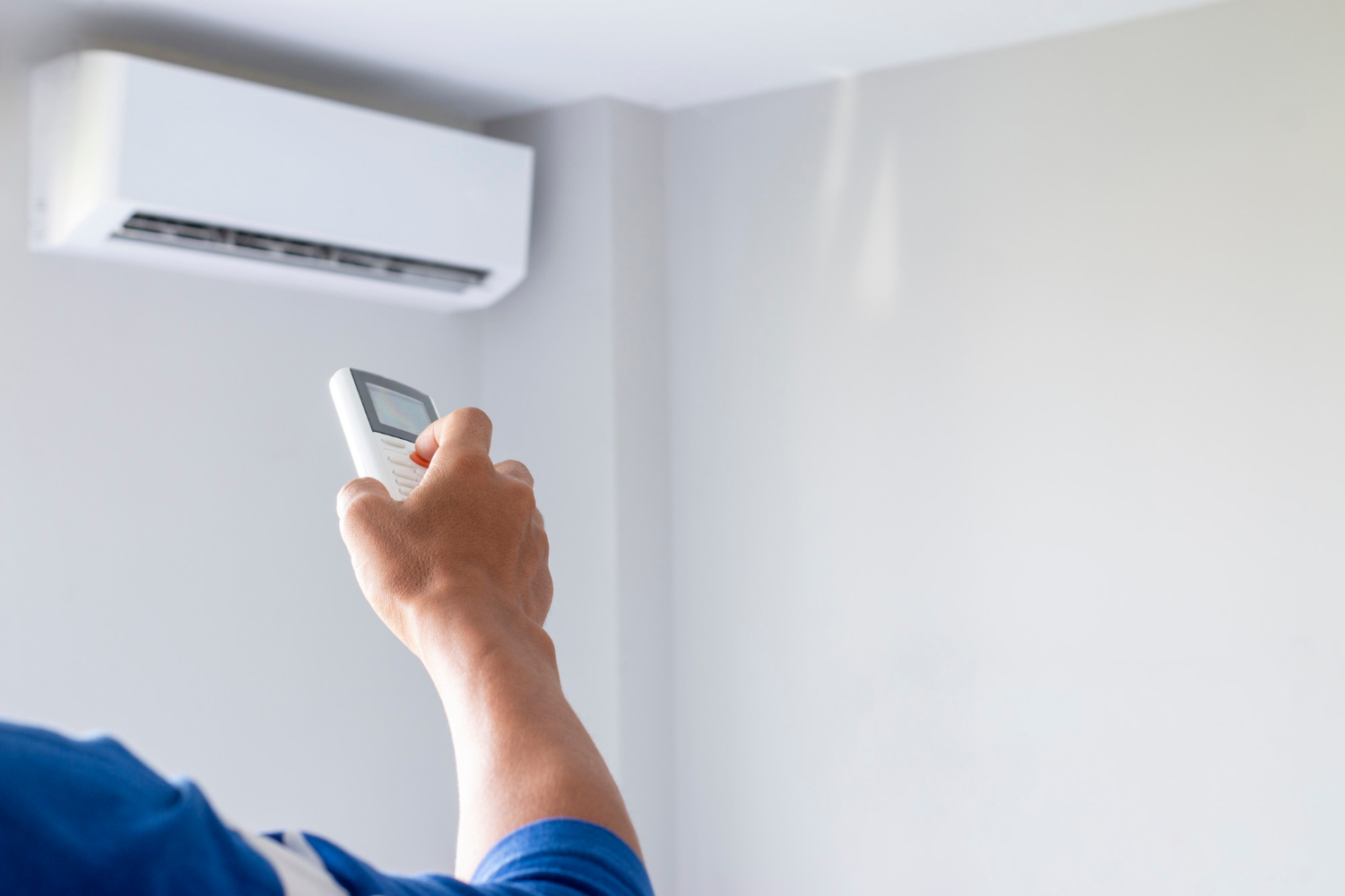 Gros plan sur la main d'un professionnel en train d'installer un climatiseur